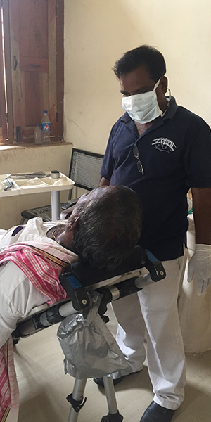 Pastor talking to patient about their teeth.
